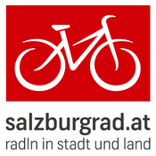 Das Logo von salzburgrad.at mit eben diesem Schriftzug untenstehend mit dem Untertitel "radln in stadt und land". Darüber auf rotem Untergrund eine Zeichung eines Fahrrads in weiß.